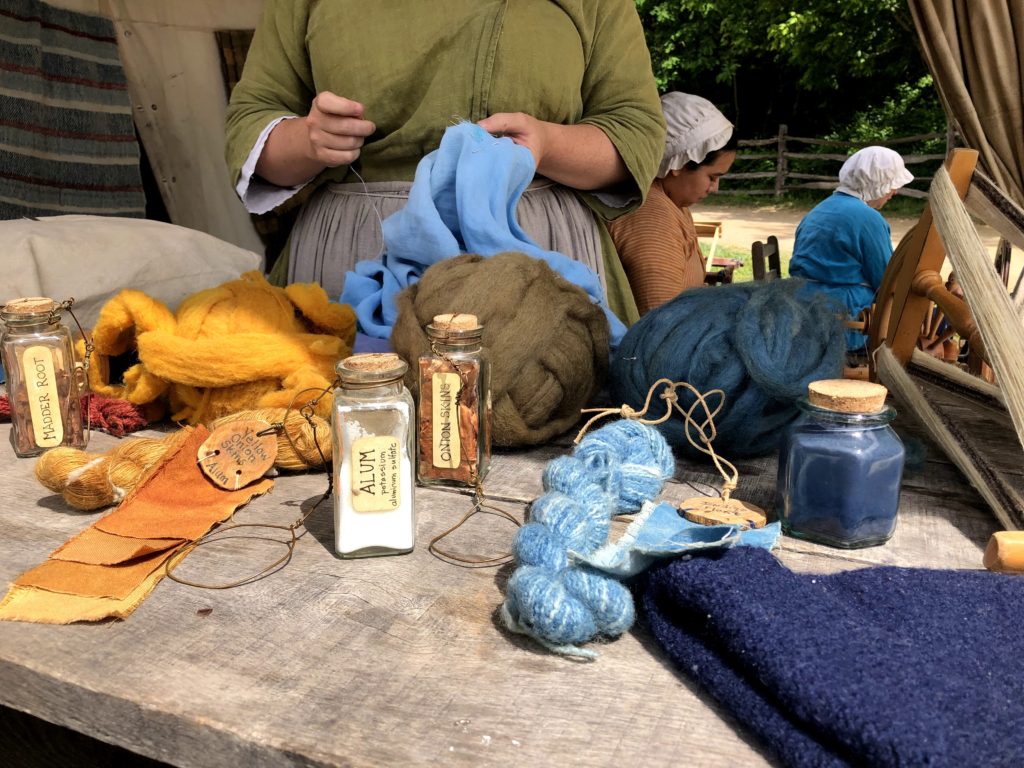 a historic display of alum, madder root, onion skins, and indigo, used as natural dyes and mordant