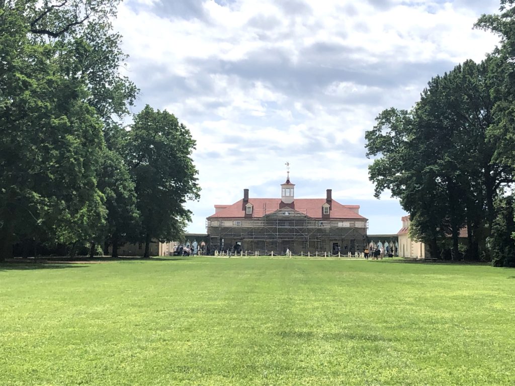 the main house at Mount Vernon, seen at the end of the bowling green, is surrounded by scaffolding