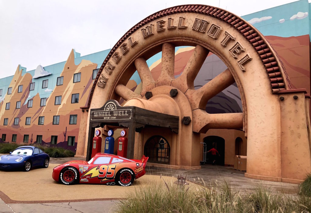 the entrance to the Wheel Well Motel is flanked by smiling race cars