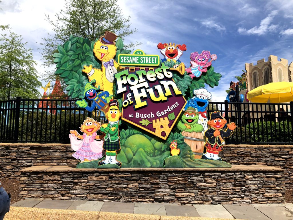 Sesame Street characters surround a sign that welcomes visitors to the Sesame Street Forest of Fun at Busch Gardens Williamsburg