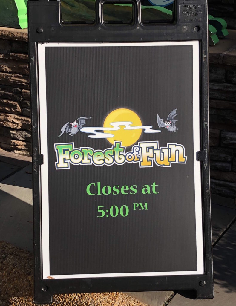 a sign with the text "Forest of Fun cloases at 5:00PM"