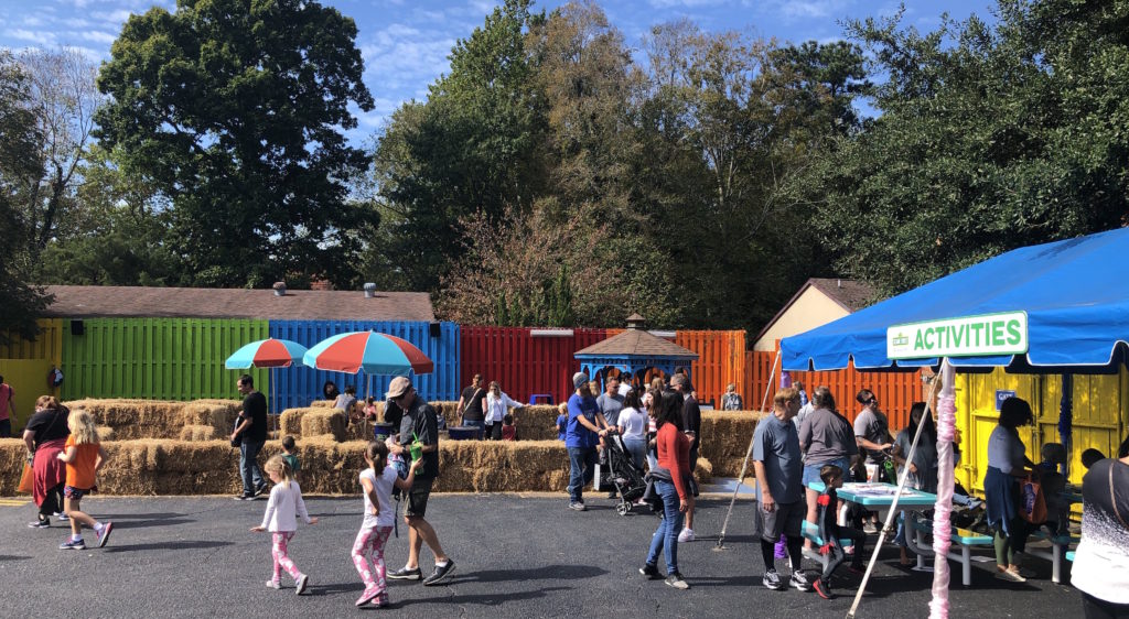 families surround a hay maze and an activities tent