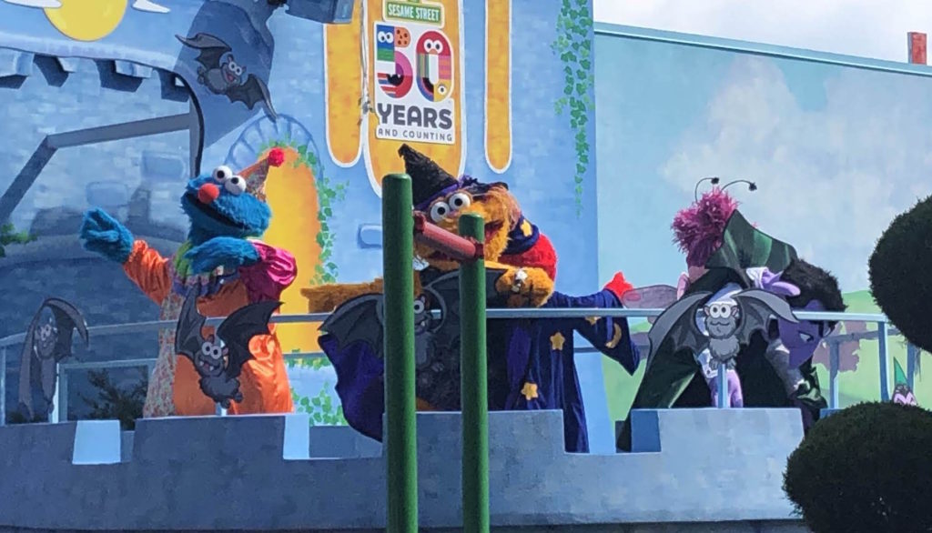 Sesame Street's Cookie Monster, Elmo, Zoe, The Count, and Abby dance on a castle stage