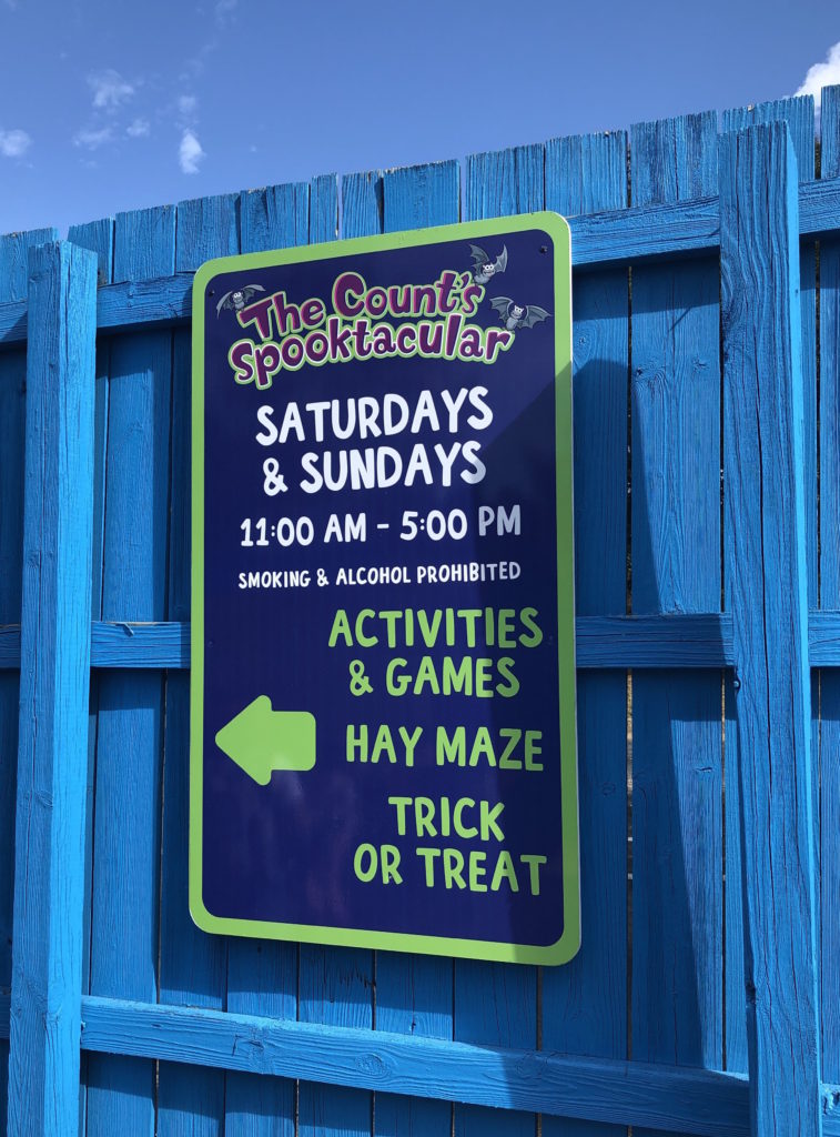 a sign details the days and times of The Count's Spooktacular