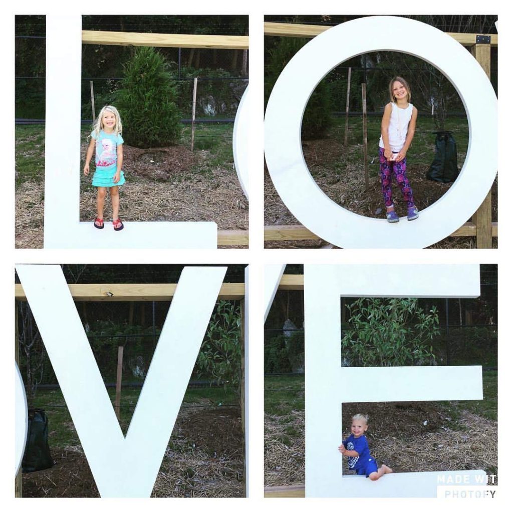 three children pose on the LOVEworks at River Mill Park in Occoquan, Virginia