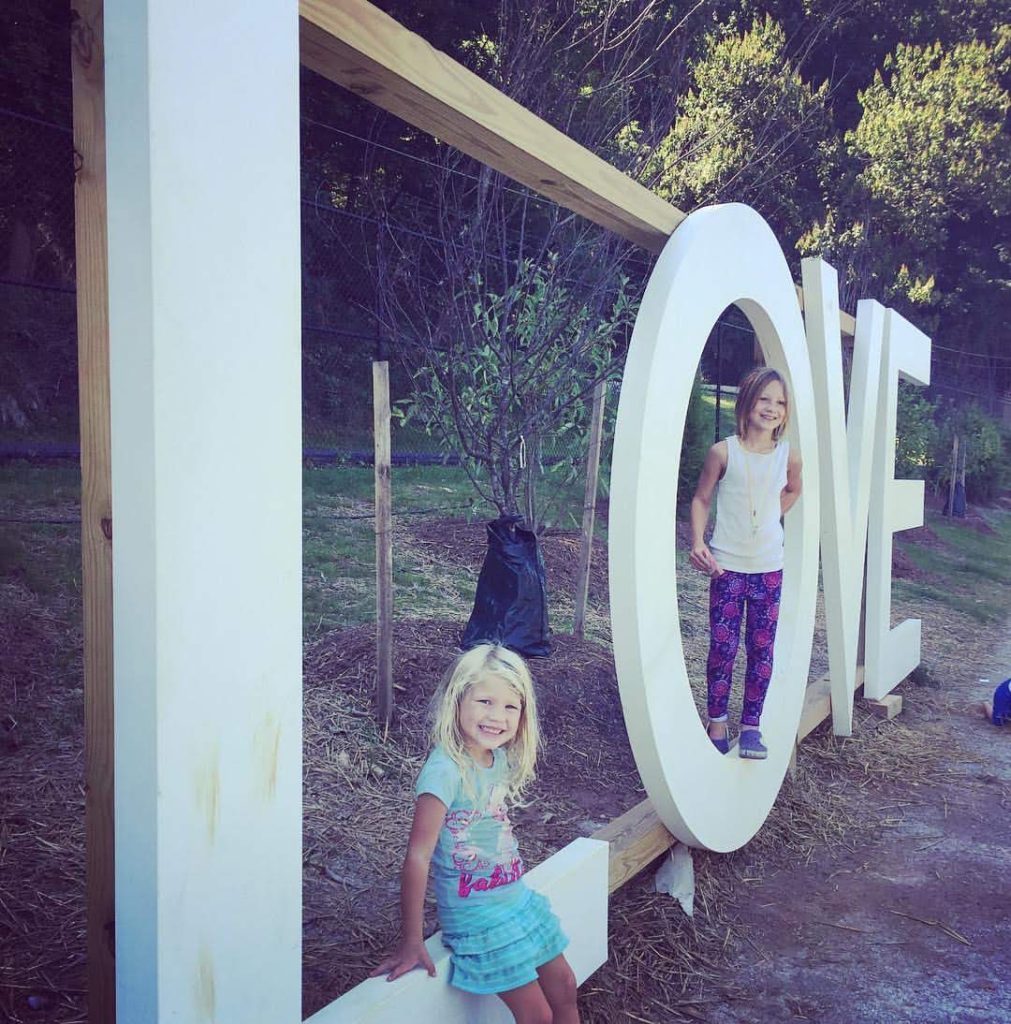 two children pose on the LOVEworks at River Mill Park in Occoquan, Virginia