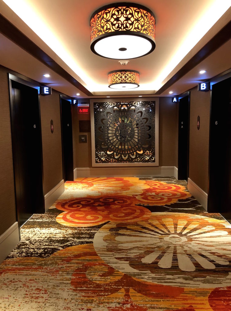 bold, floral print carpeting, lighting, and mirrors in the lobby of Disney's Coronado Springs: Gran Destino Tower