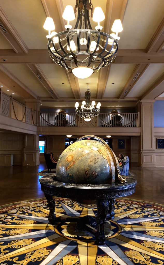 balconies overlook a large globe lit by chandeliers