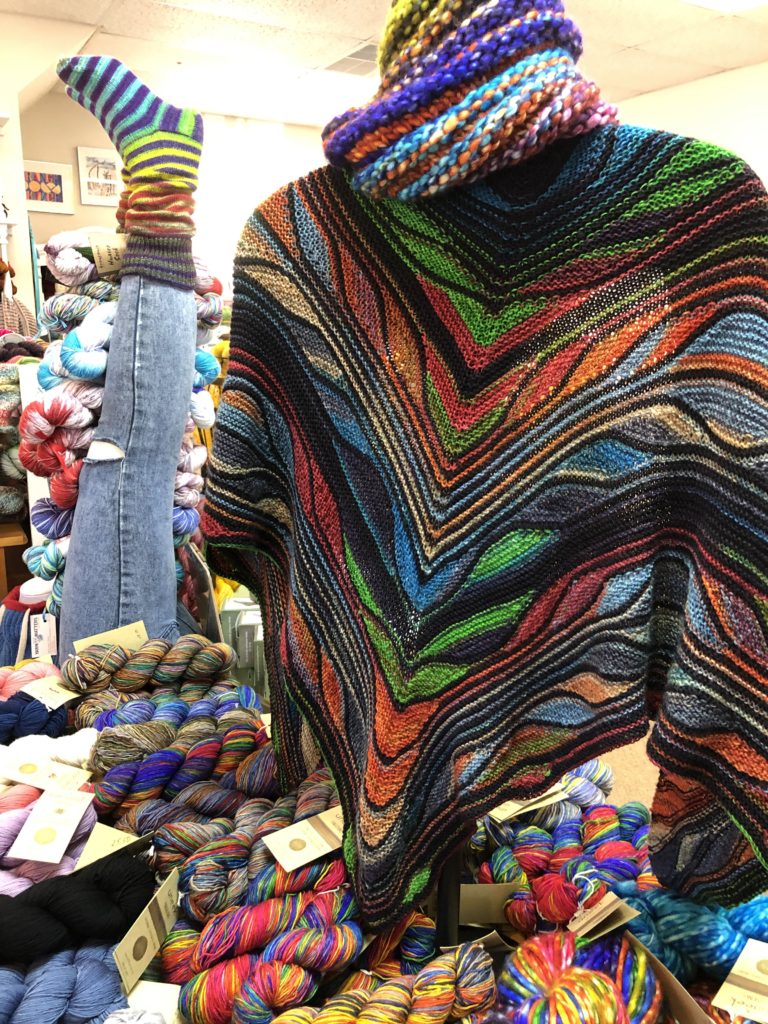 a hand-knit shawl and sock display
