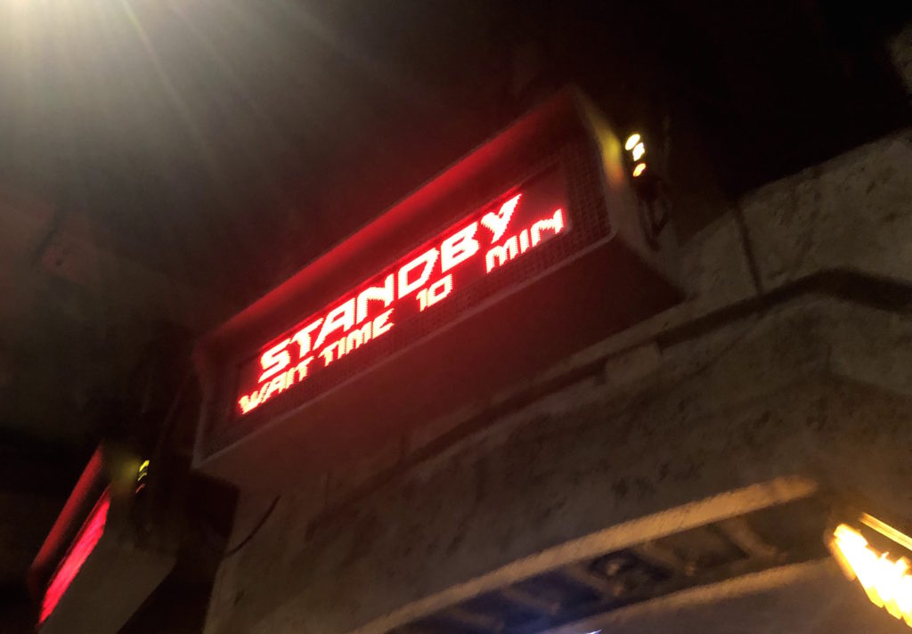 an attraction sign reads "standby wait time 10 min"