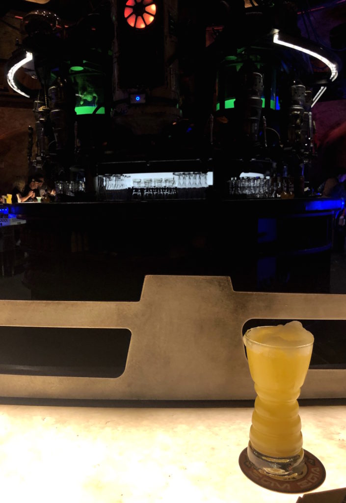 a Fuzzy Tauntaun sits in front of the bar at Oga's Cantina