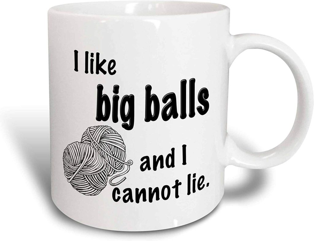 a coffee mug with a bullet skein of yarn on the front that reads "I like big balls and I cannot lie."