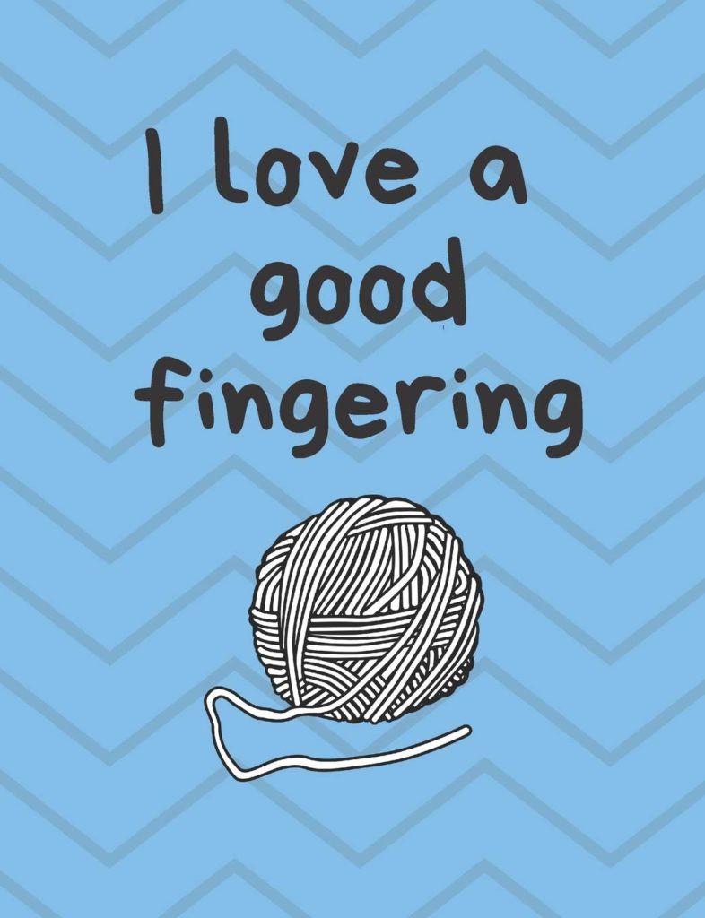 A notebook with a ball of yarn that reads "I love a good fingering."