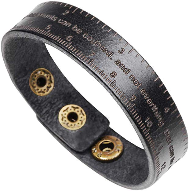 a leather bracelet with markings denoting measurements and script that reads "Not everything that counts can be counted and not everything that can be counted counts."