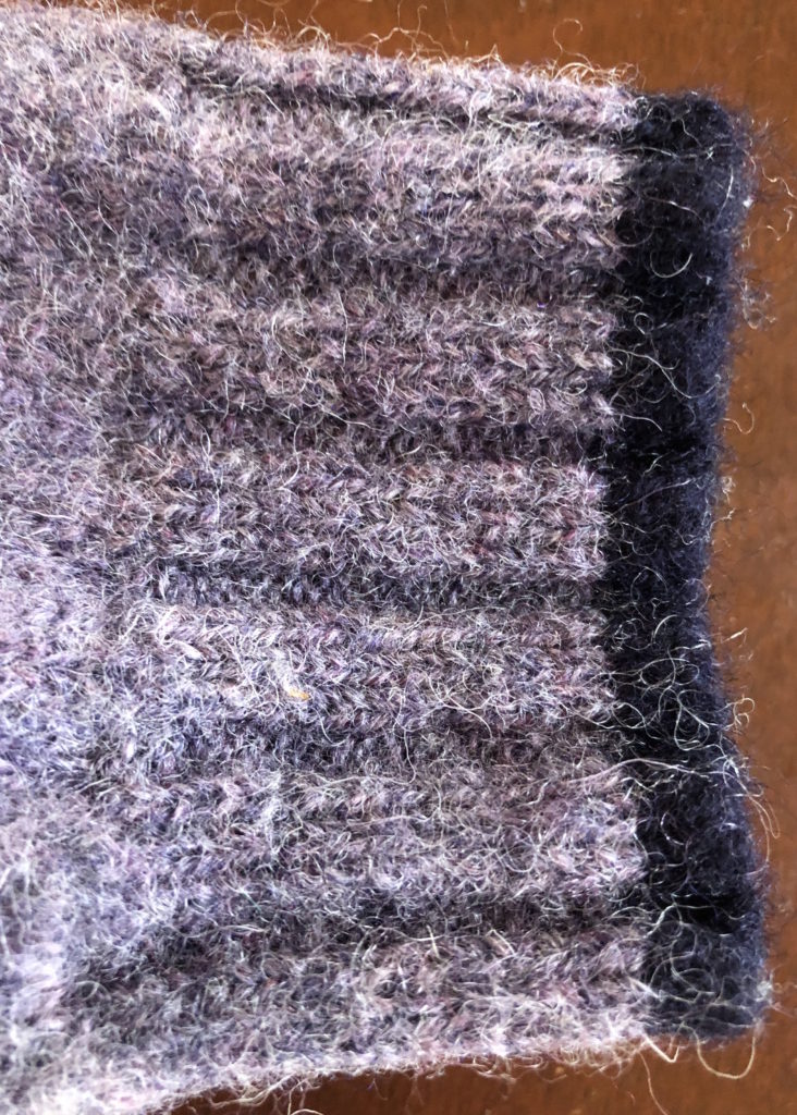 the ribbed cuff of a wool sweater