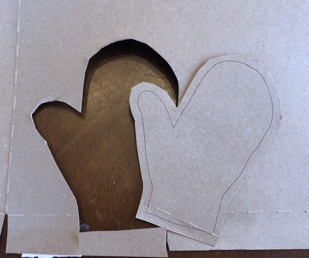 a mitten shape cut out of cardboard