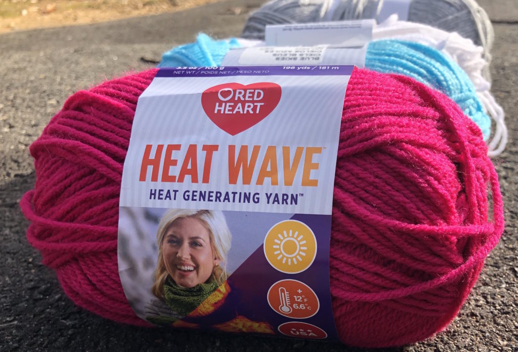 four skeins of yarn, the first with a Heat Wave label