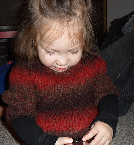 a young girl wearing a wool sweater