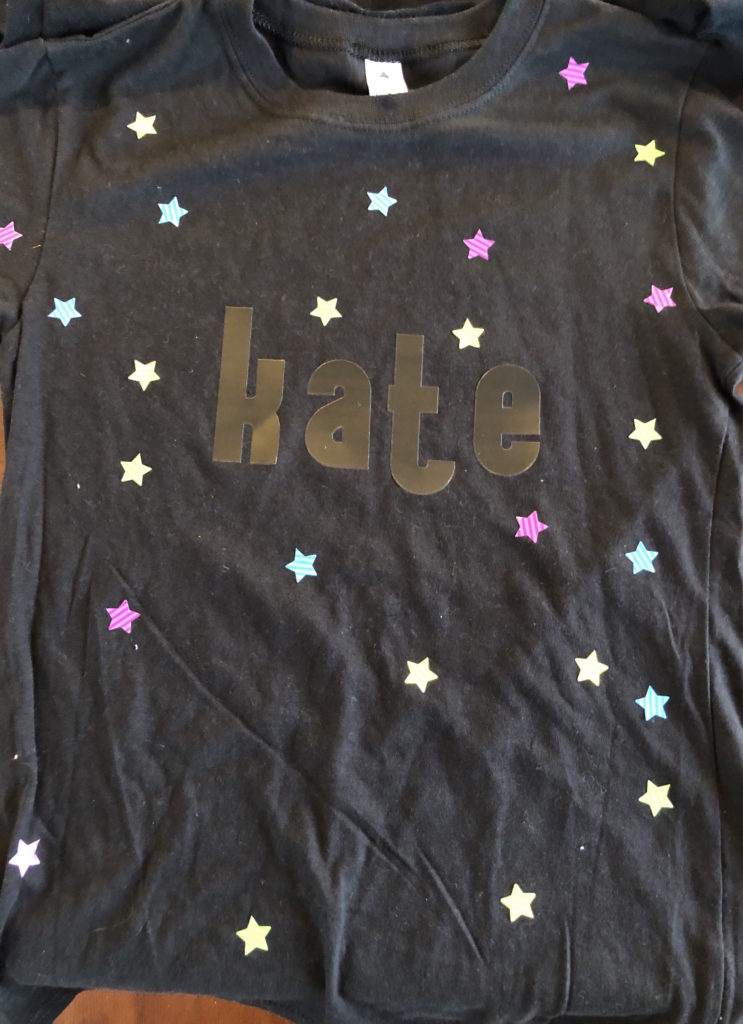a shirt is covered with alphabet and star stickers (before bleach is applied)