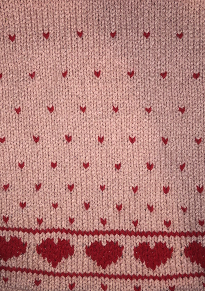 a close-up of the heart pattern on the knitted towel