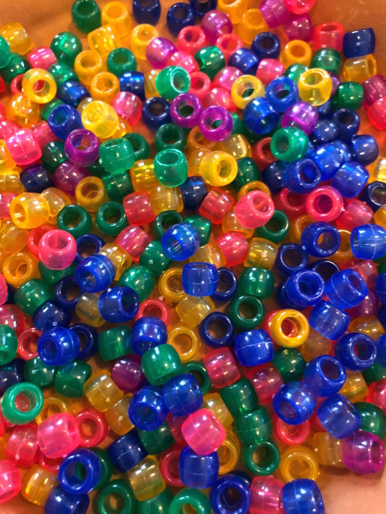 a pile of multicolored, translucent pony beads