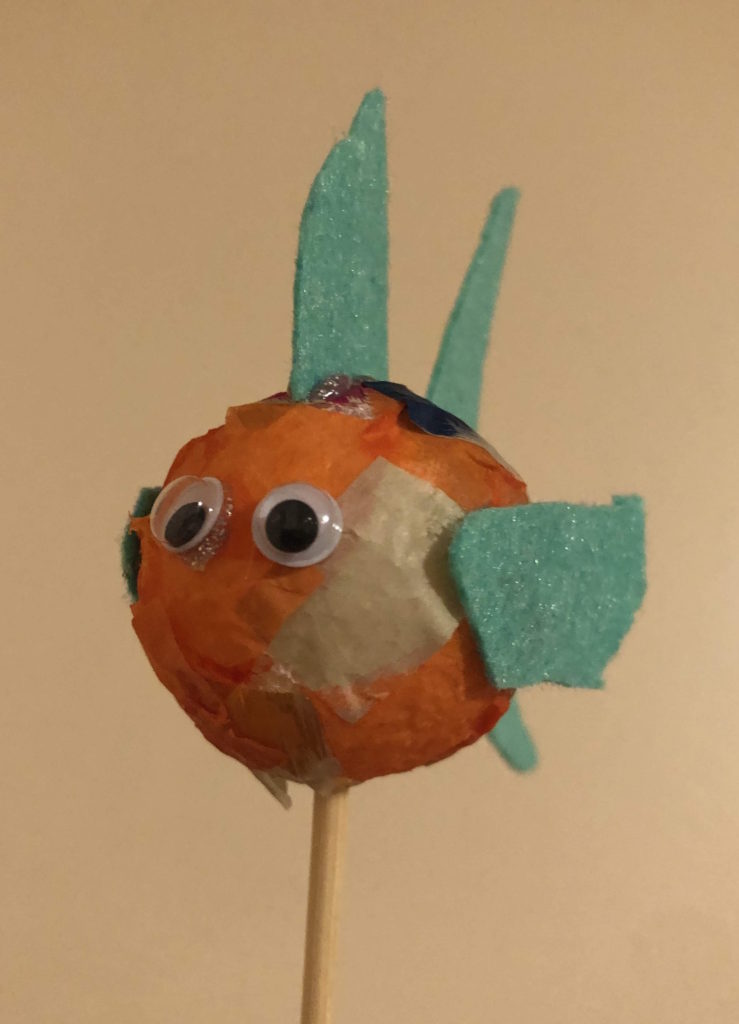 a foam ball fish: decoupaged styrofoam ball with googly eyes and felt fins on a dowel