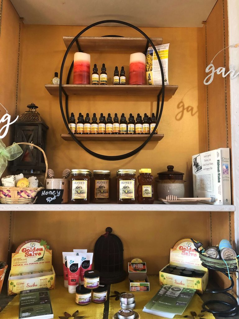 essential oils, salves, and honey line the shelves of the apothecary