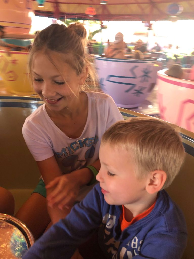 two children smile on the Mad Tea Party attraction at Walt Disney World