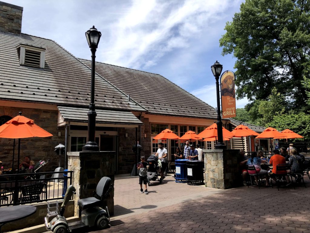 umbrellas shade diners at picnic tables outside of Mane Grill