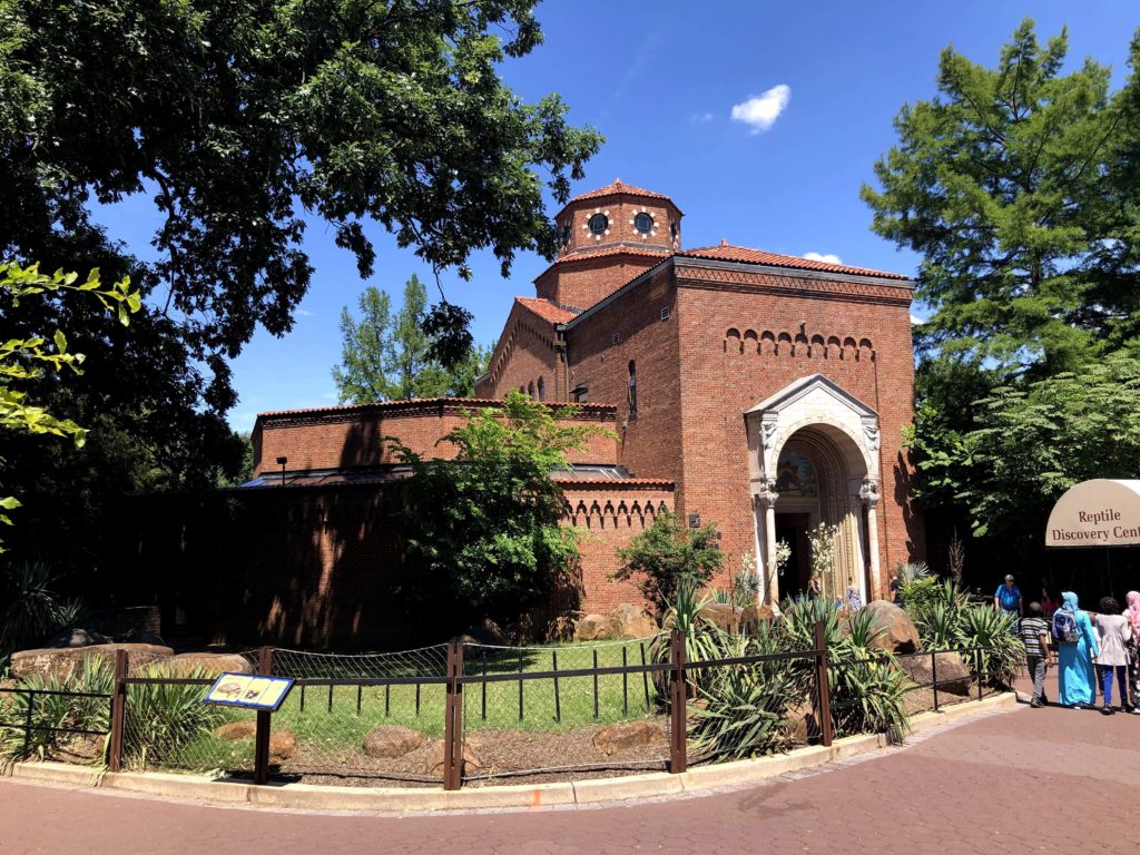 a large, brick structure dating back to the 1800s features a short tower and rounded entryway