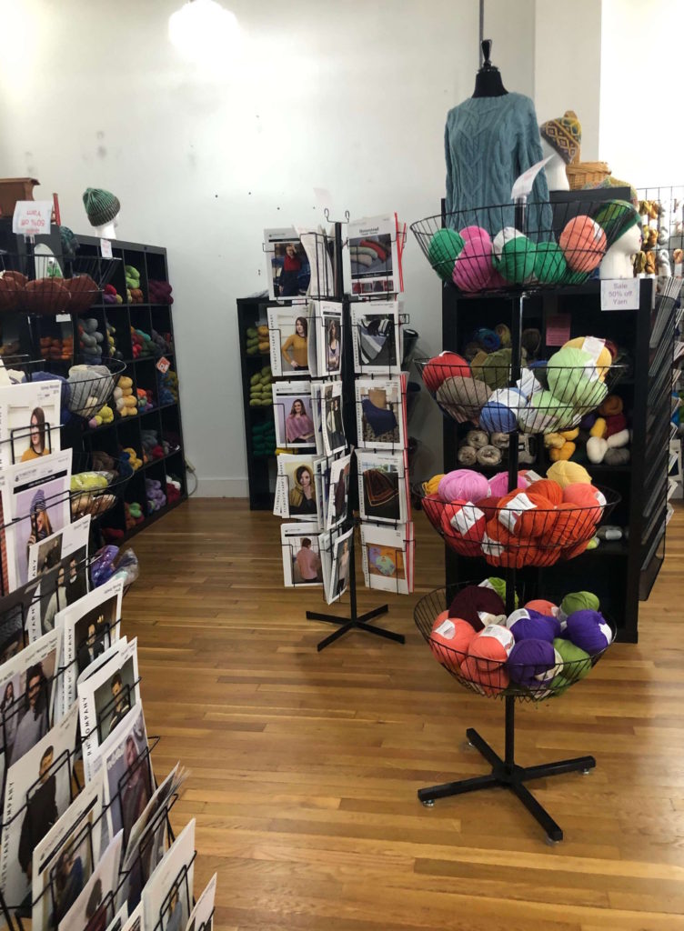 Yarnia of Old Town shop interior: baskets of yarn and pattern racks