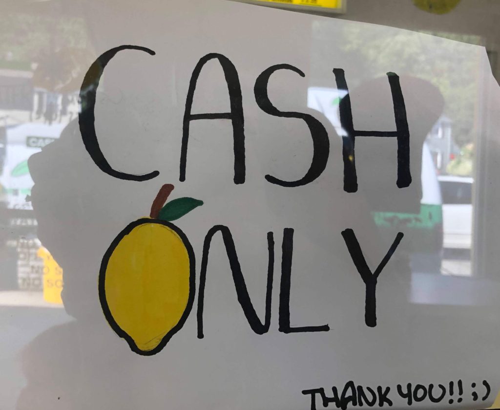 a sign reads "Cash only. Thank you!! ;)"