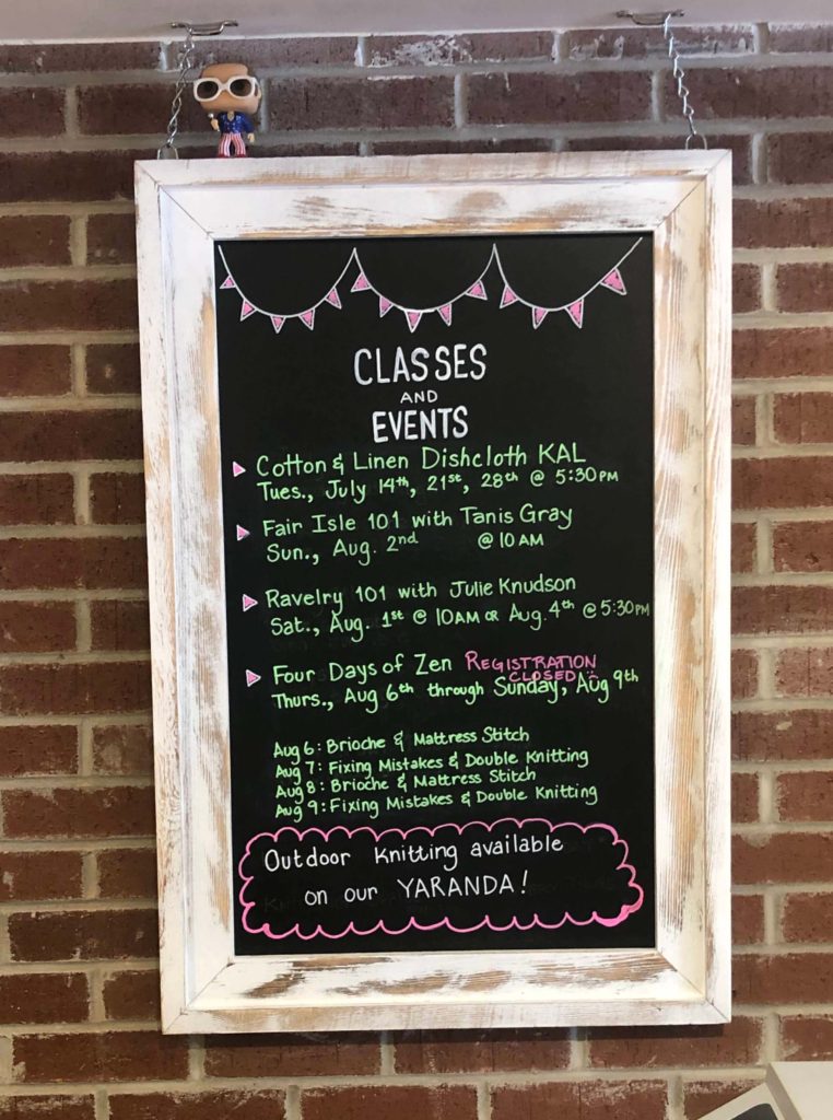a chalkboard sign displaying upcoming classes and events