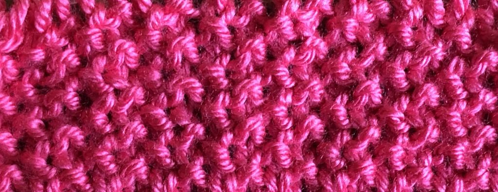 a close-up of fabric knitted in seed stitch