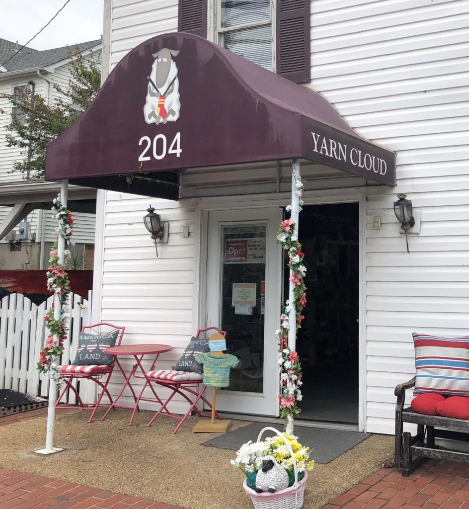 the entrance to Yarn Cloud is wrapped in flowers and has ample outdoor seating