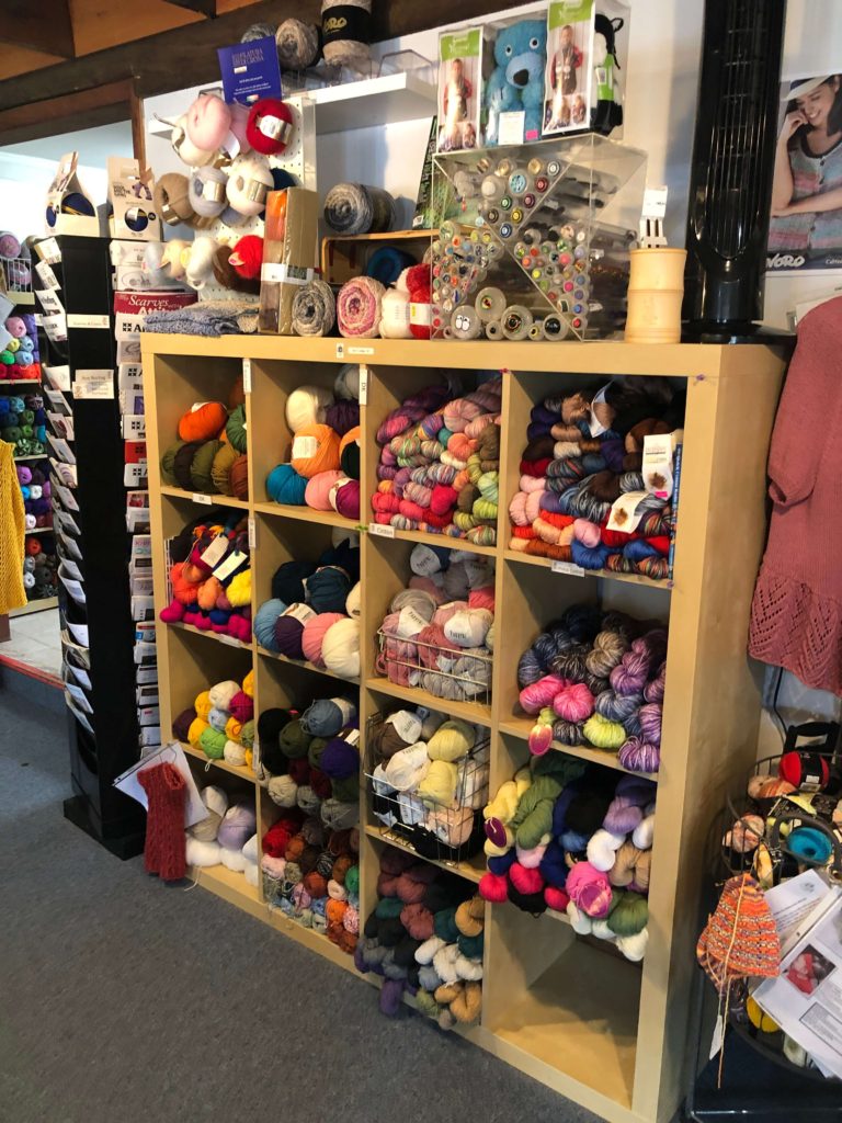 the yarn at yarn cloud is stacked high on shelves