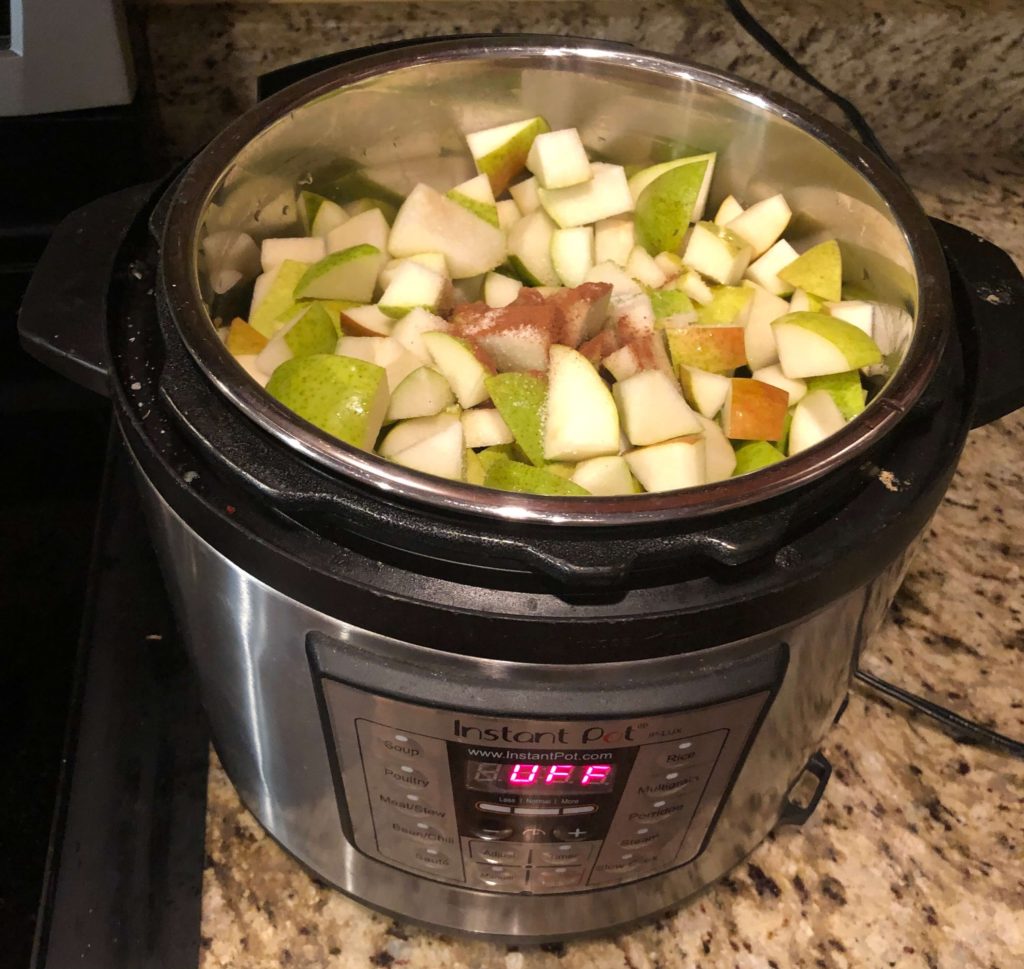 a pressure cooker full of pears topped with cinnamon