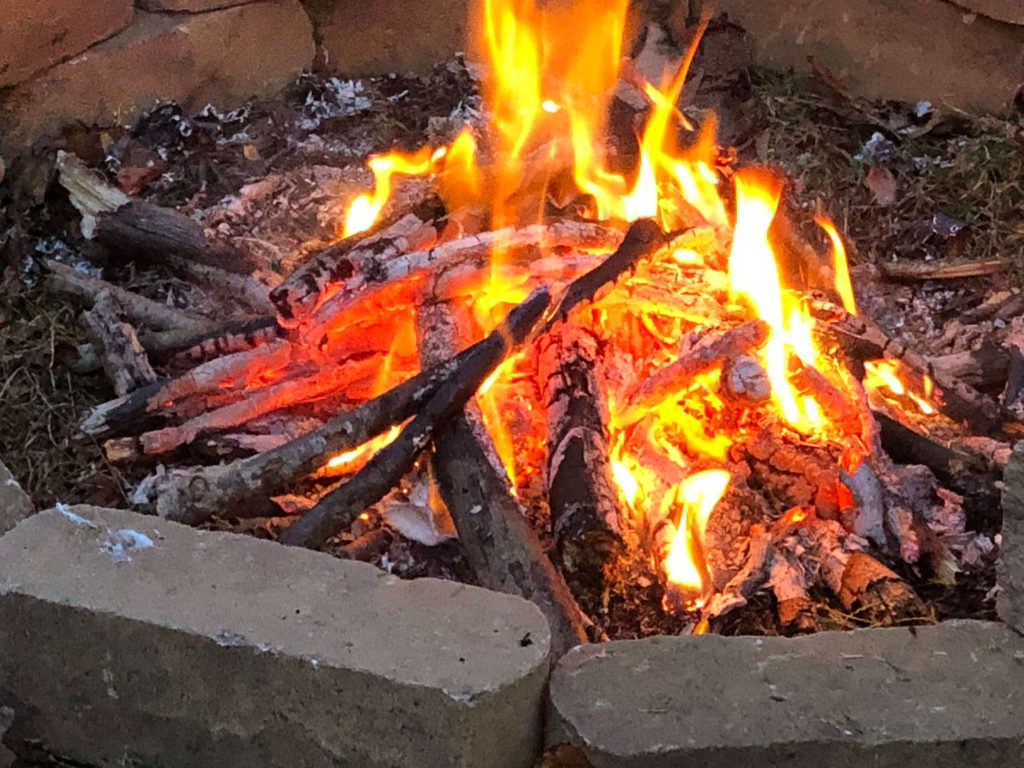 a roaring campfire lined with stones