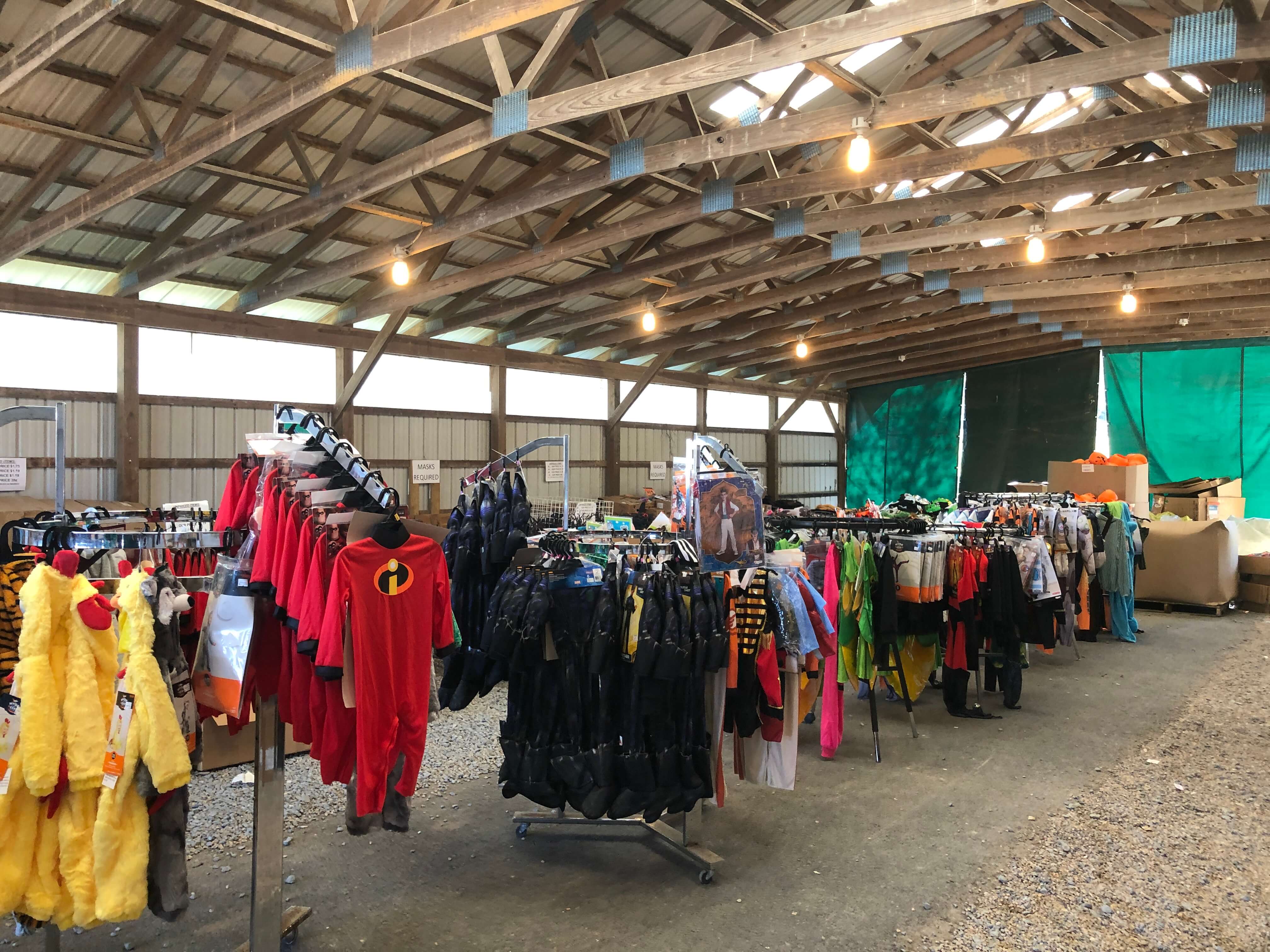 In the Green Valley Book Fair outdoor pavilion, Halloween costumes line the racks.