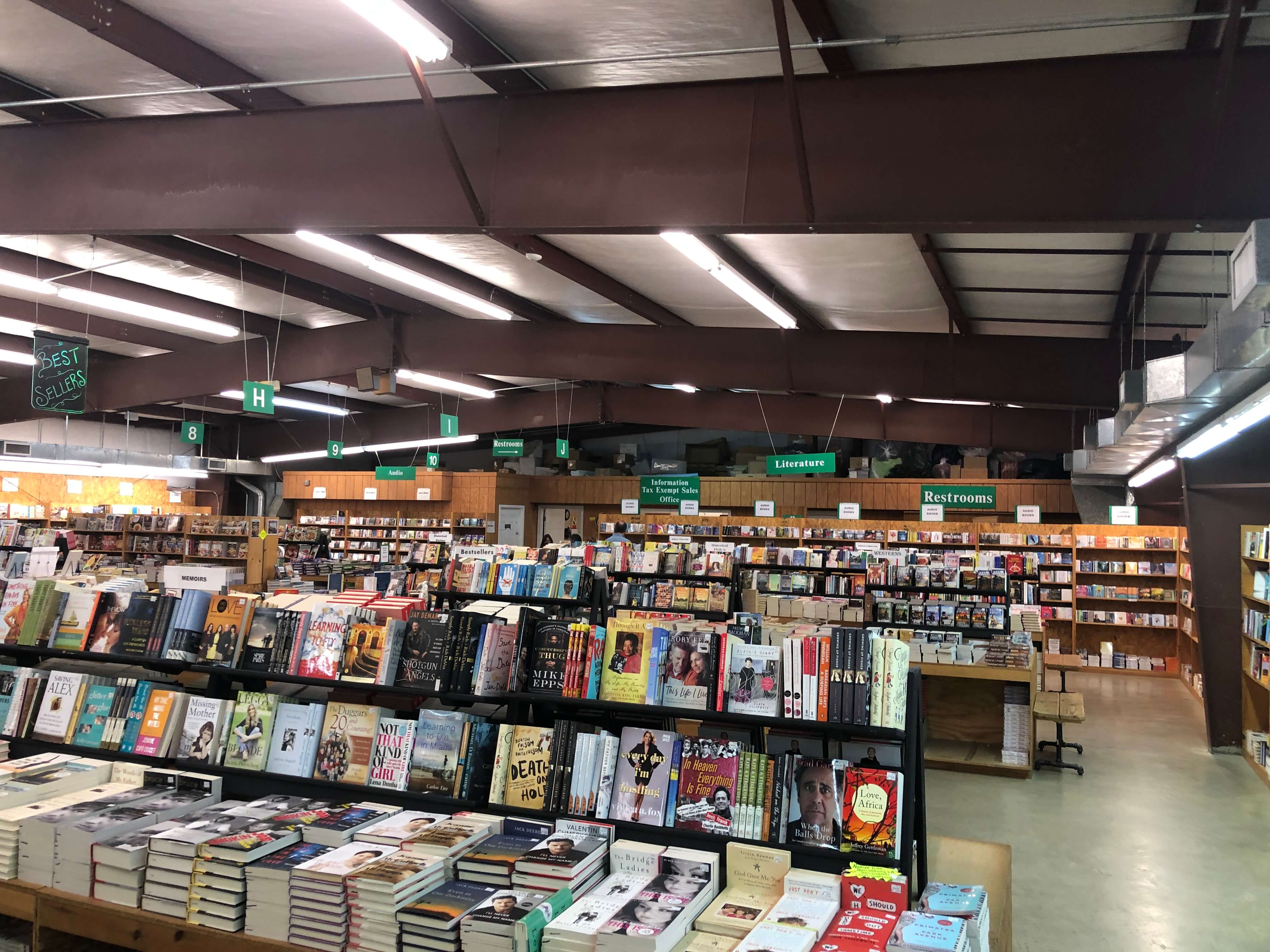 books line the shelves of a warehouse at the Green Valley Book Fair