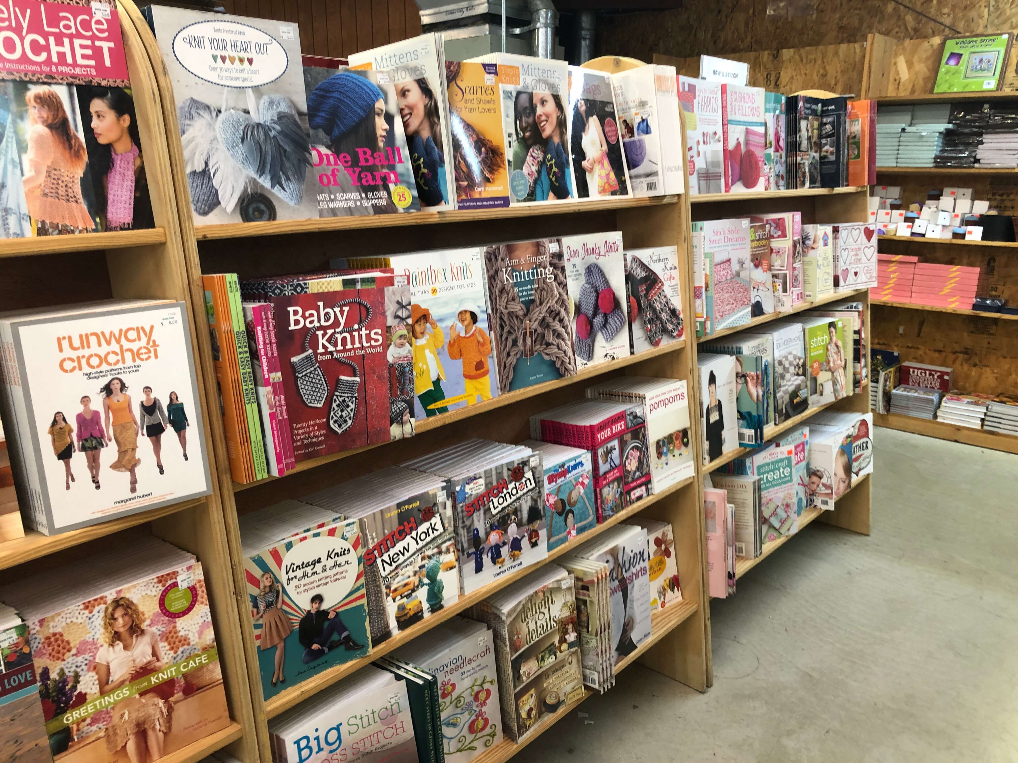 a long shelf of knitting and crochet books on display at the Green Valley Book Fair