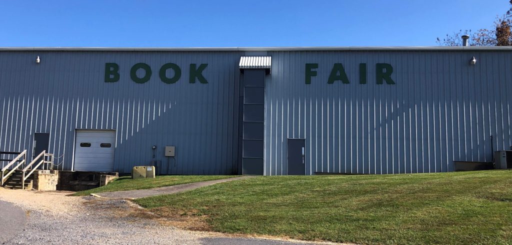 a large warehouse reads BOOK FAIR