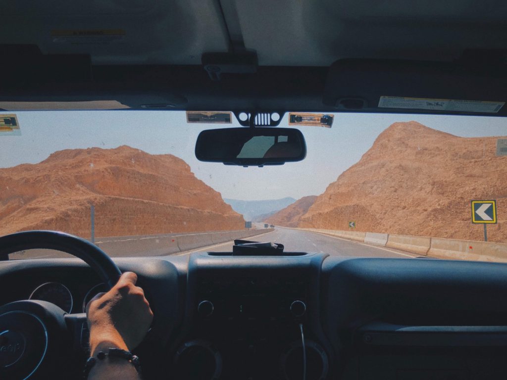 a peek ahead on an interstate from the car while passing through giant rock formations