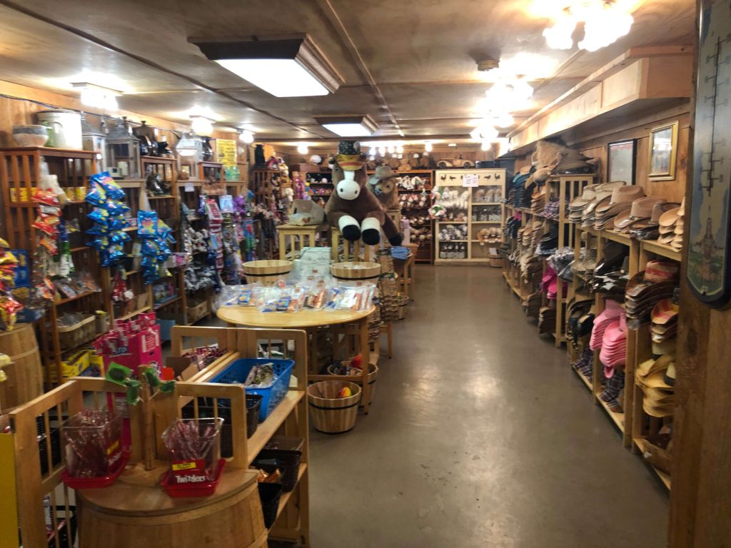 shop shelves lined with cowboy hats, stuffed horses and bears, and candies