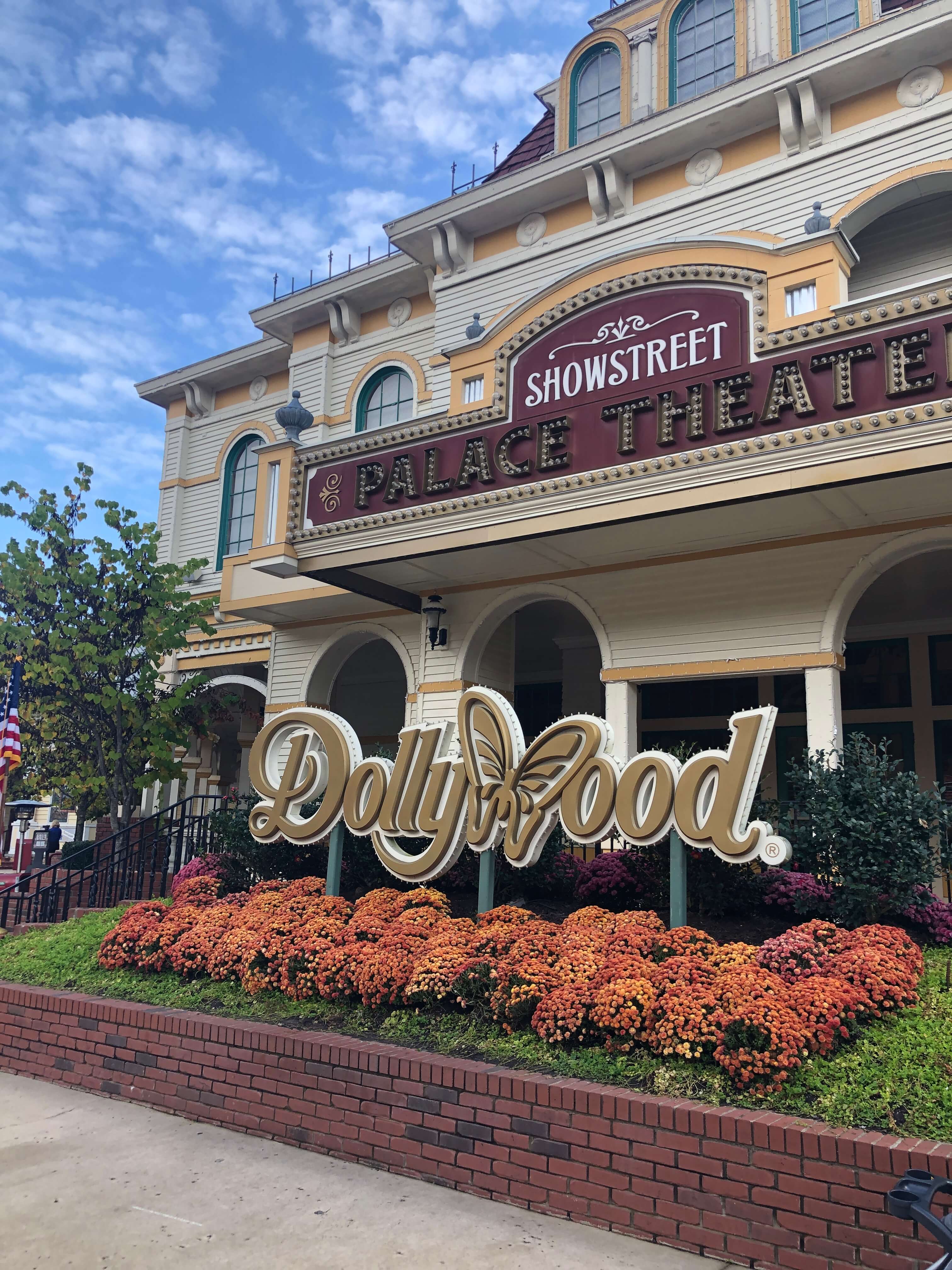 the exterior of the Showstreet Palace Theatre at Dollywood is surrounded by flowers