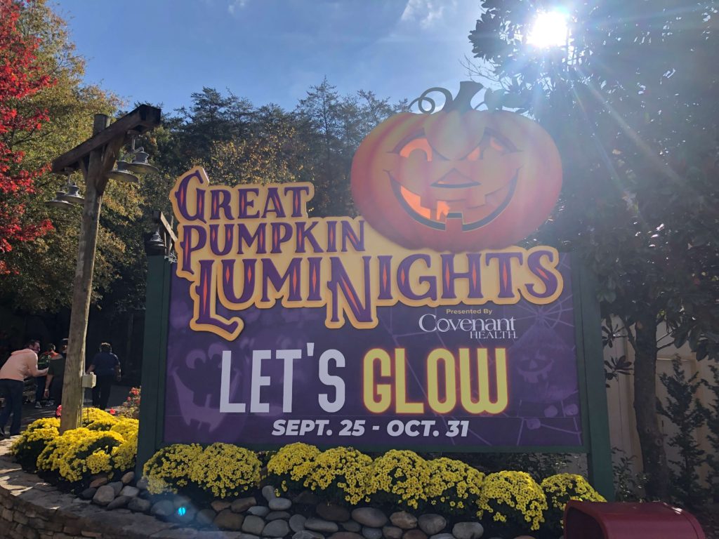 sun shines down on a giant sign reading: GREAT PUMPKIN LUMINIGHTS LET's GLOW SEPT 25 - OCT 31