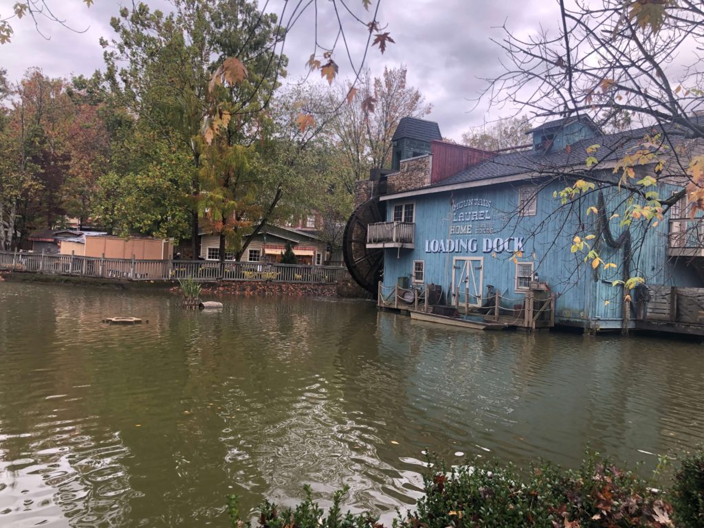 a waterwheel outside a mill reads LOADING DOCK