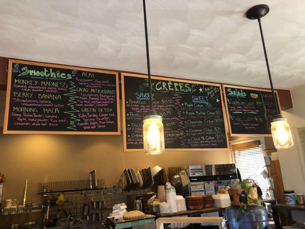 a chalkboard menu lit by mason jar lights displays the café's offerings