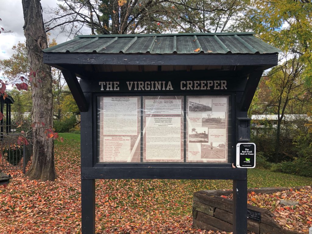 a sheltered notice board reading THE VIRGINIA CREEPER is full of information about the trail