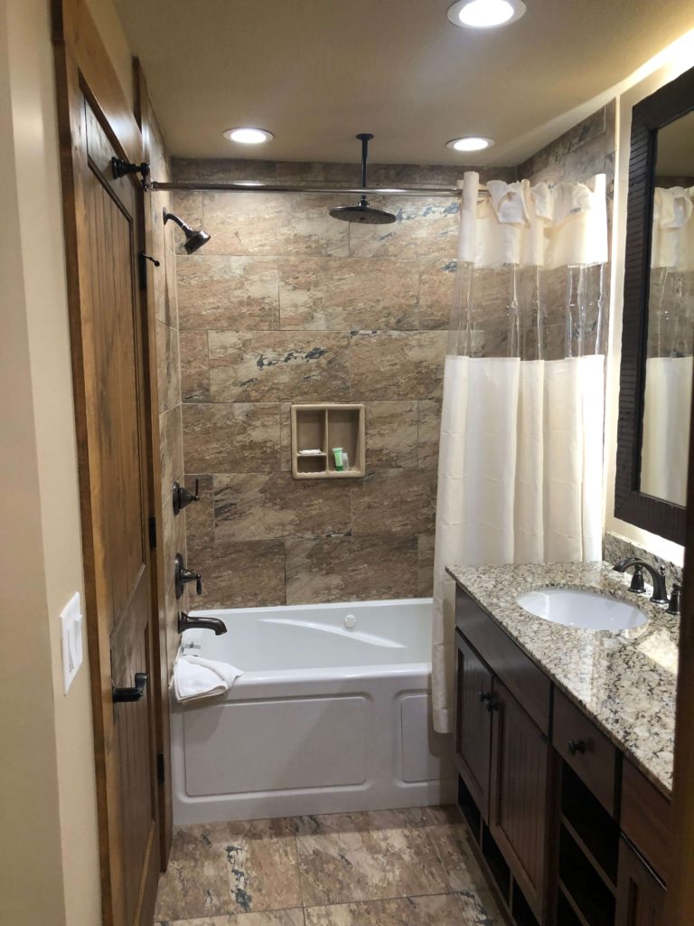a bathroom with two sinks and a tub